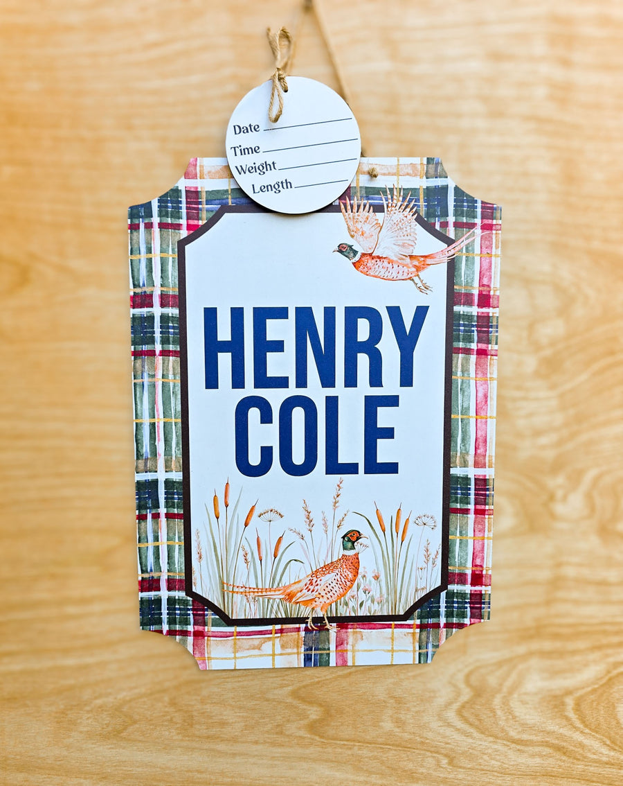 Personalized pheasant and plaid hospital door hanger with watercolor pheasants, navy baby name, red green plaid border and birth stat round