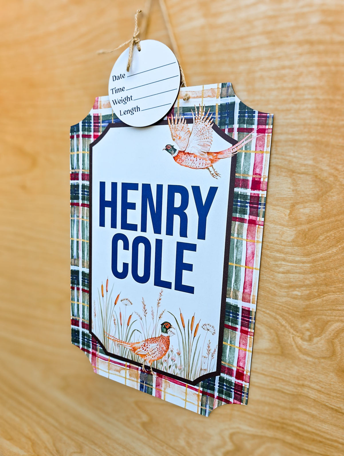 Flying watercolor pheasant above personalized baby name on plaid hospital sign