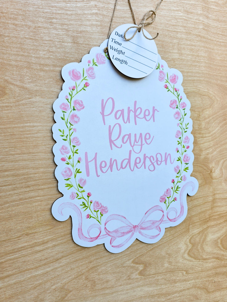 Watercolor pink rose garland and green vines on custom baby hospital door sign
