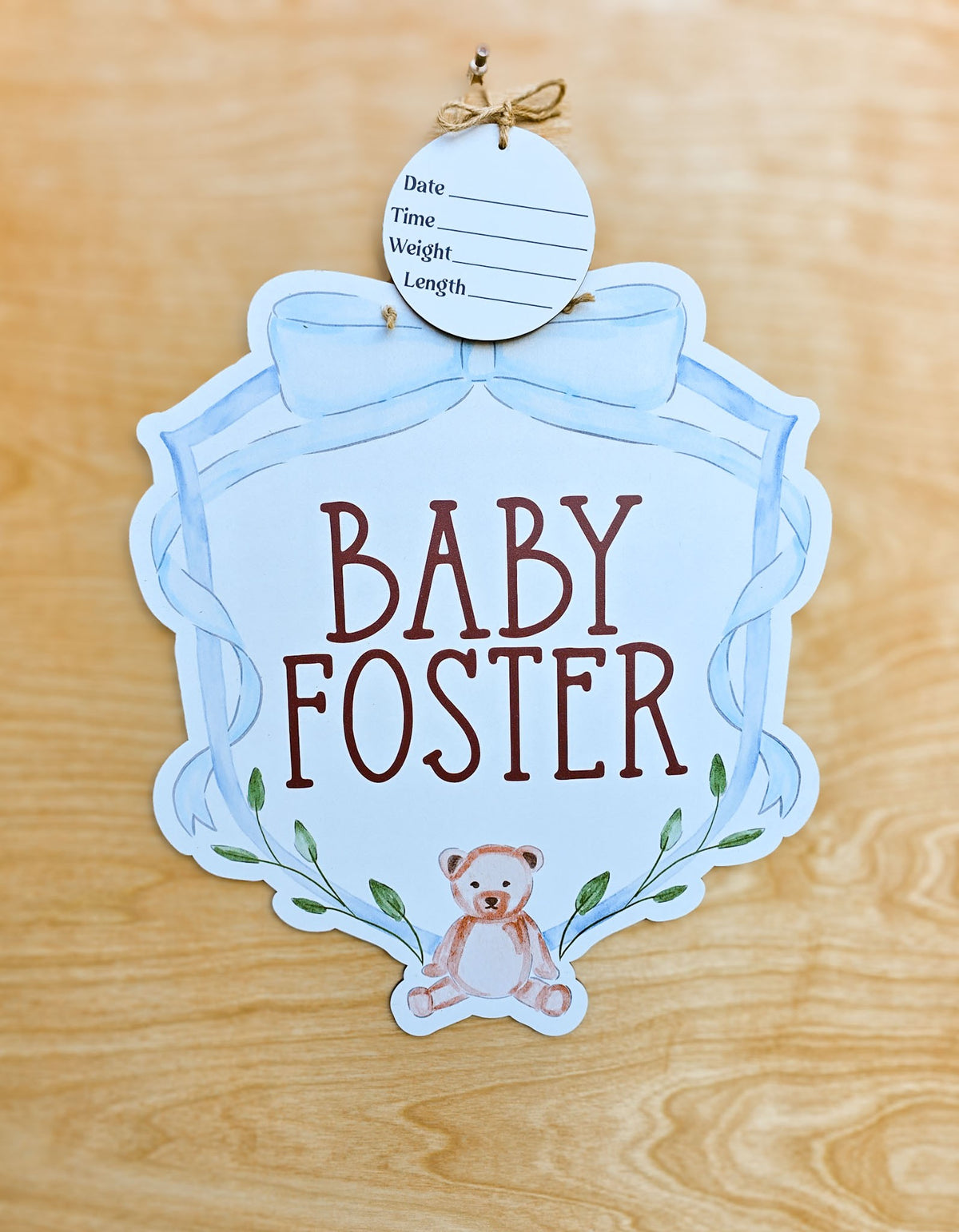 Personalized blue bow and teddy bear hospital door hanger with watercolor ribbon frame, baby name, greenery and detachable birth stat round