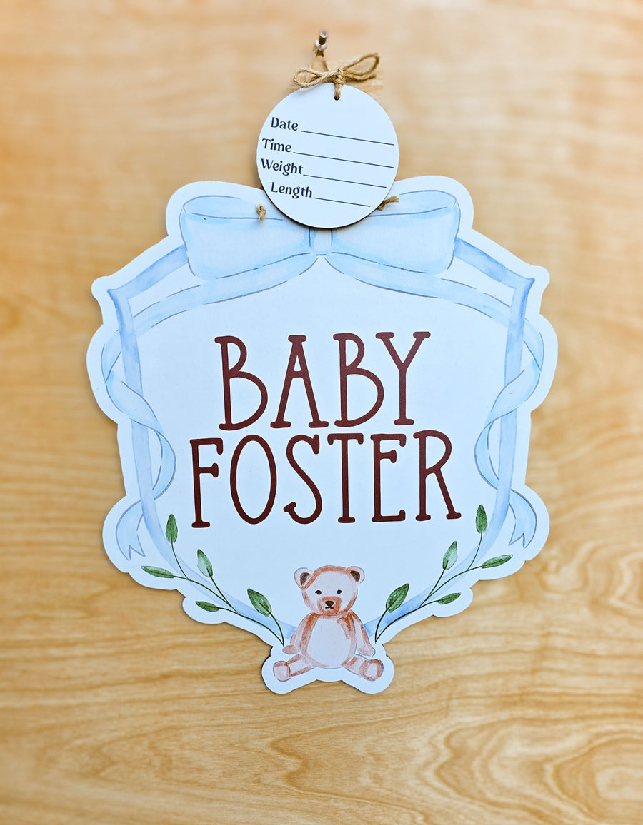 Personalized blue bow and teddy bear hospital door hanger with watercolor ribbon frame, baby name, greenery and detachable birth stat round
