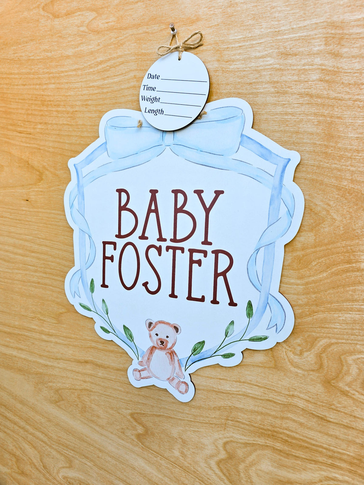 Soft blue watercolor bow and ribbon frame on custom baby hospital door sign