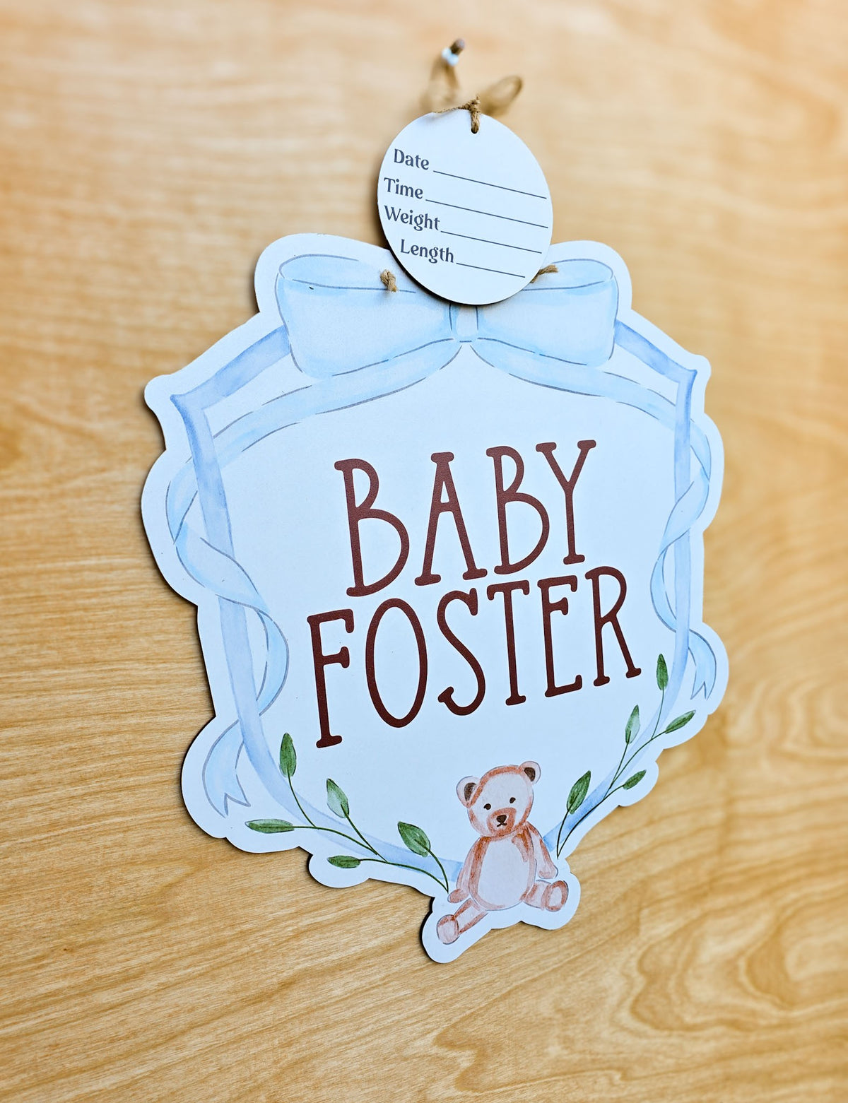 Watercolor teddy bear with green leafy accents on personalized baby name sign