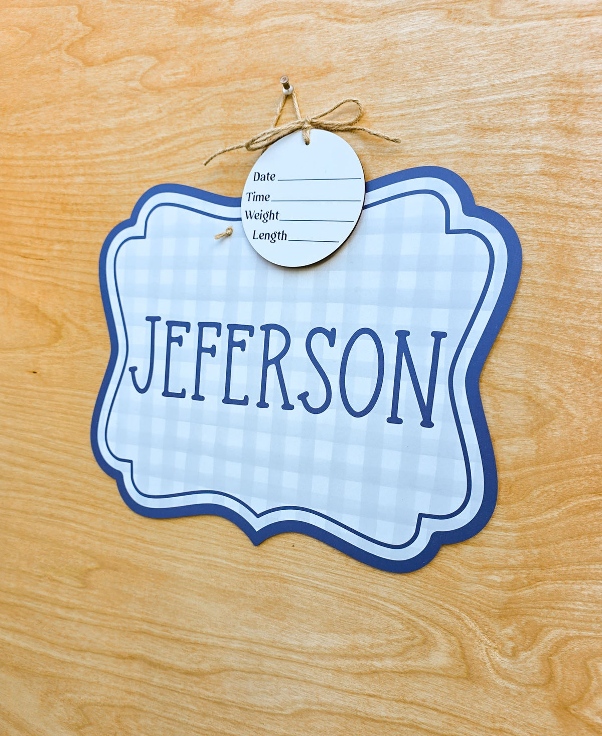 Soft blue and white gingham pattern with navy double border on baby name sign