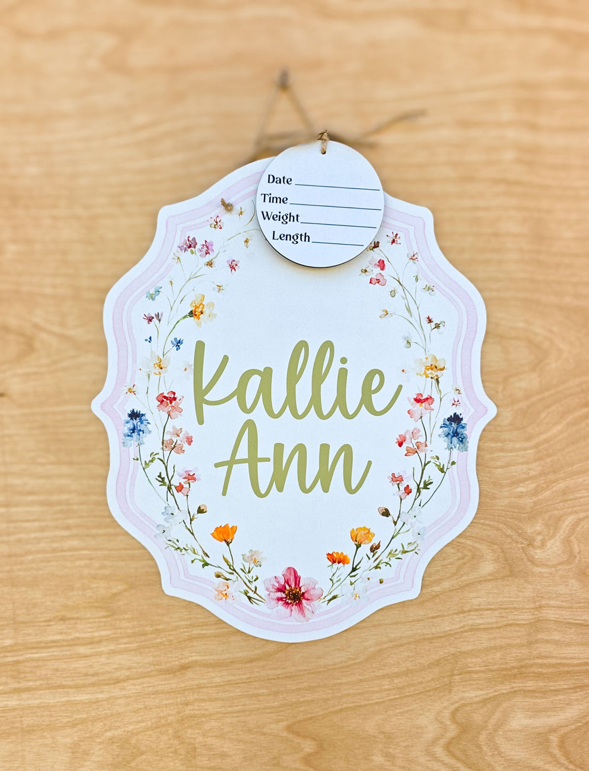 Personalized watercolor wildflower crest hospital door hanger with pink border, floral artwork, custom baby name and birth stat round