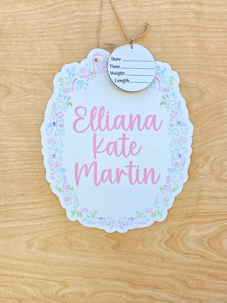 Personalized pastel floral scalloped hospital door hanger with pink baby name and detachable birth announcement round