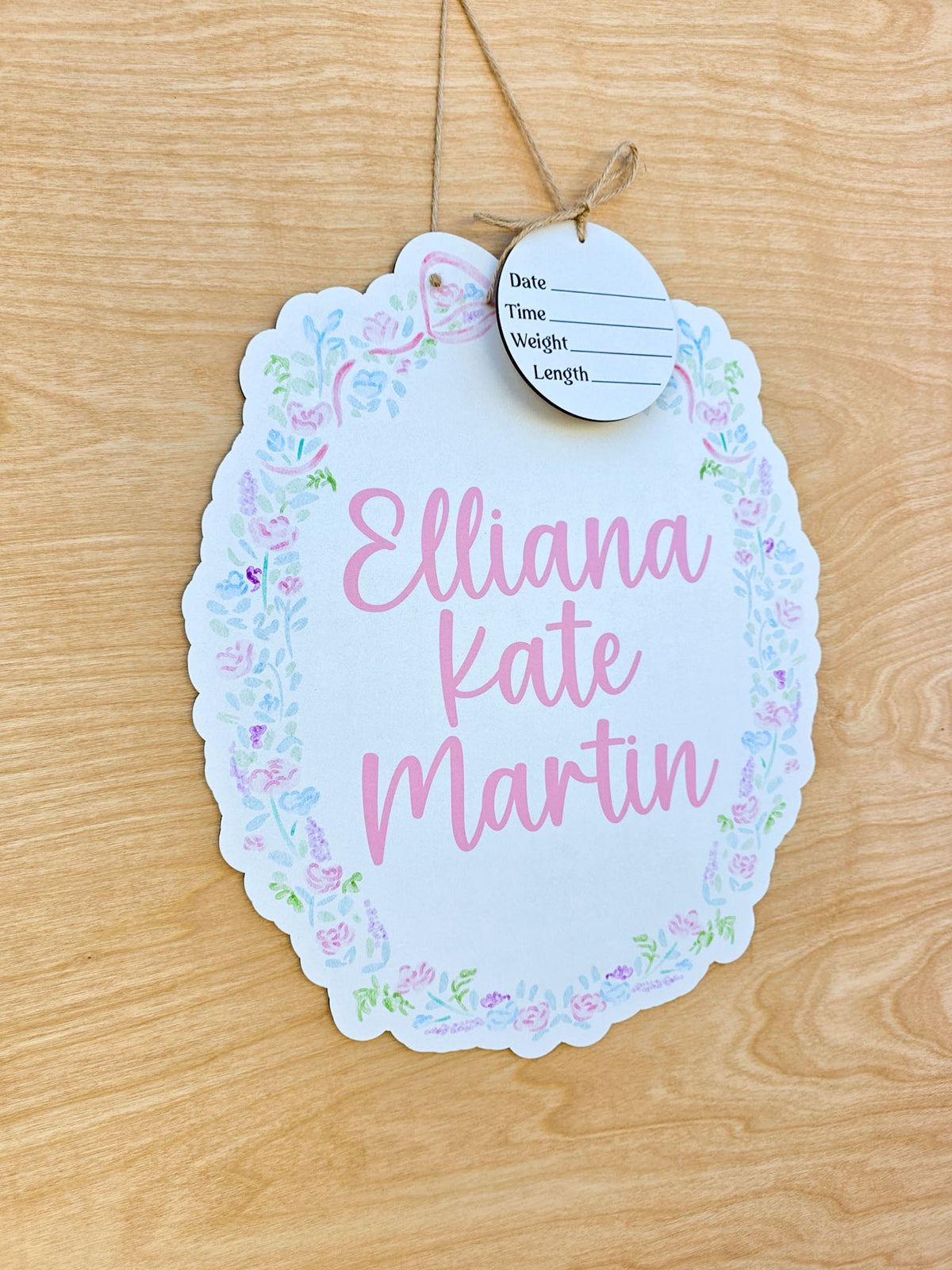 Scalloped oval baby hospital door sign with pastel pink, blue, and lavender watercolor floral border