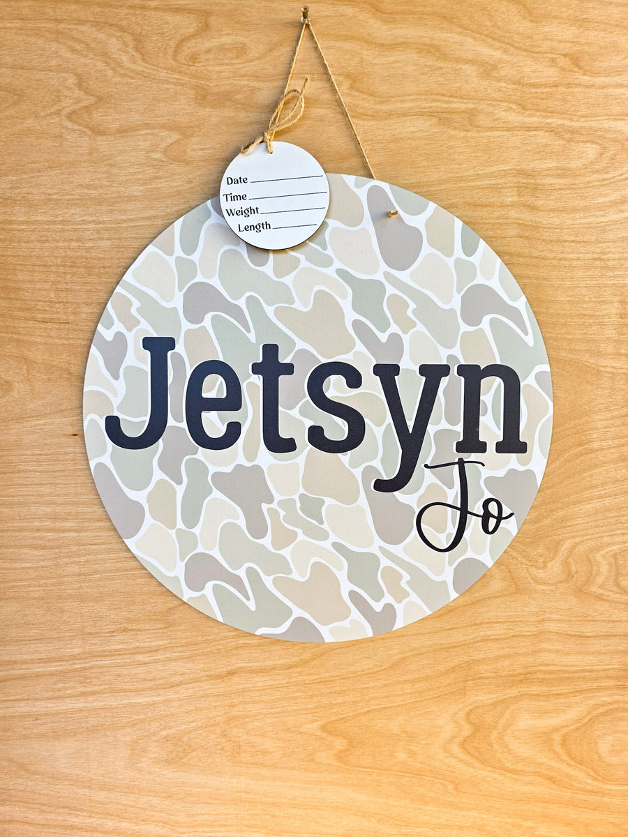 Personalized neutral duck camo round hospital door hanger with beige sage camouflage pattern, black baby name and detachable birth stat round