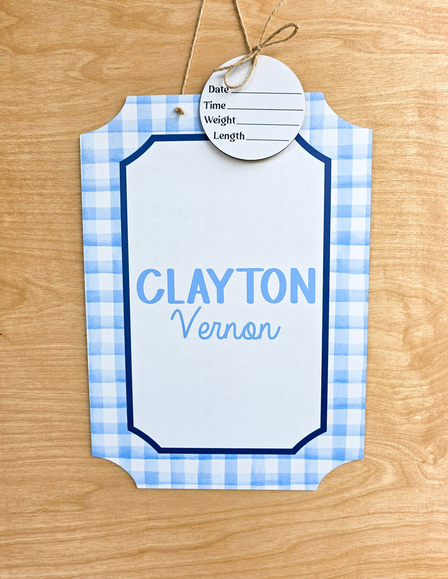 Light blue and white gingham pattern with navy border on custom baby name sign
