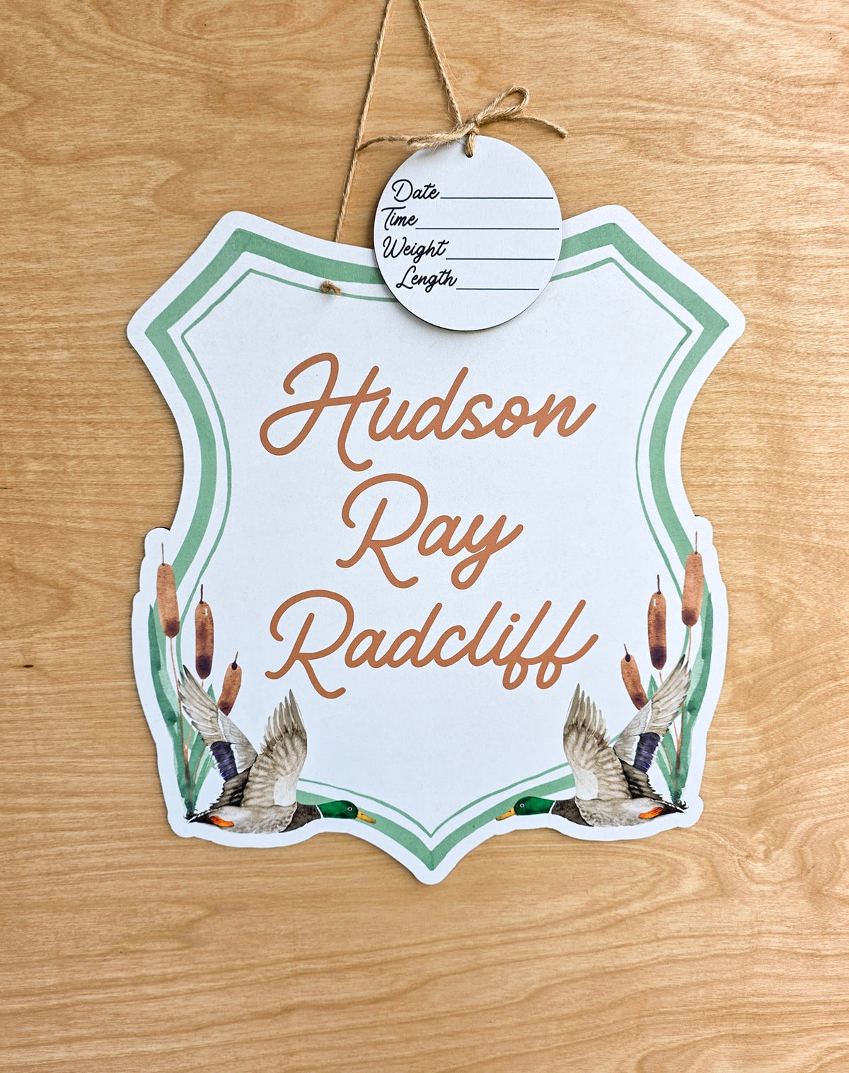 Personalized flying mallard duck hospital door hanger with two watercolor ducks, cattails, sage green crest border and detachable birth stat round