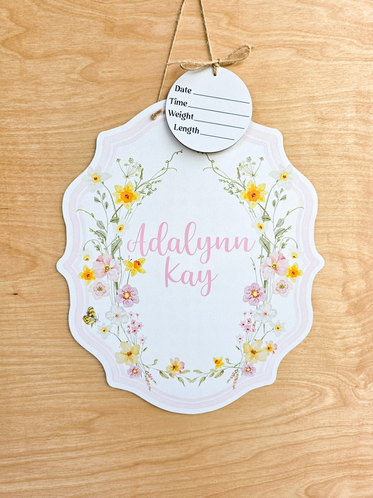 Personalized spring garden floral crest hospital door hanger with pink and yellow watercolor flowers, butterfly, baby name and birth stat round