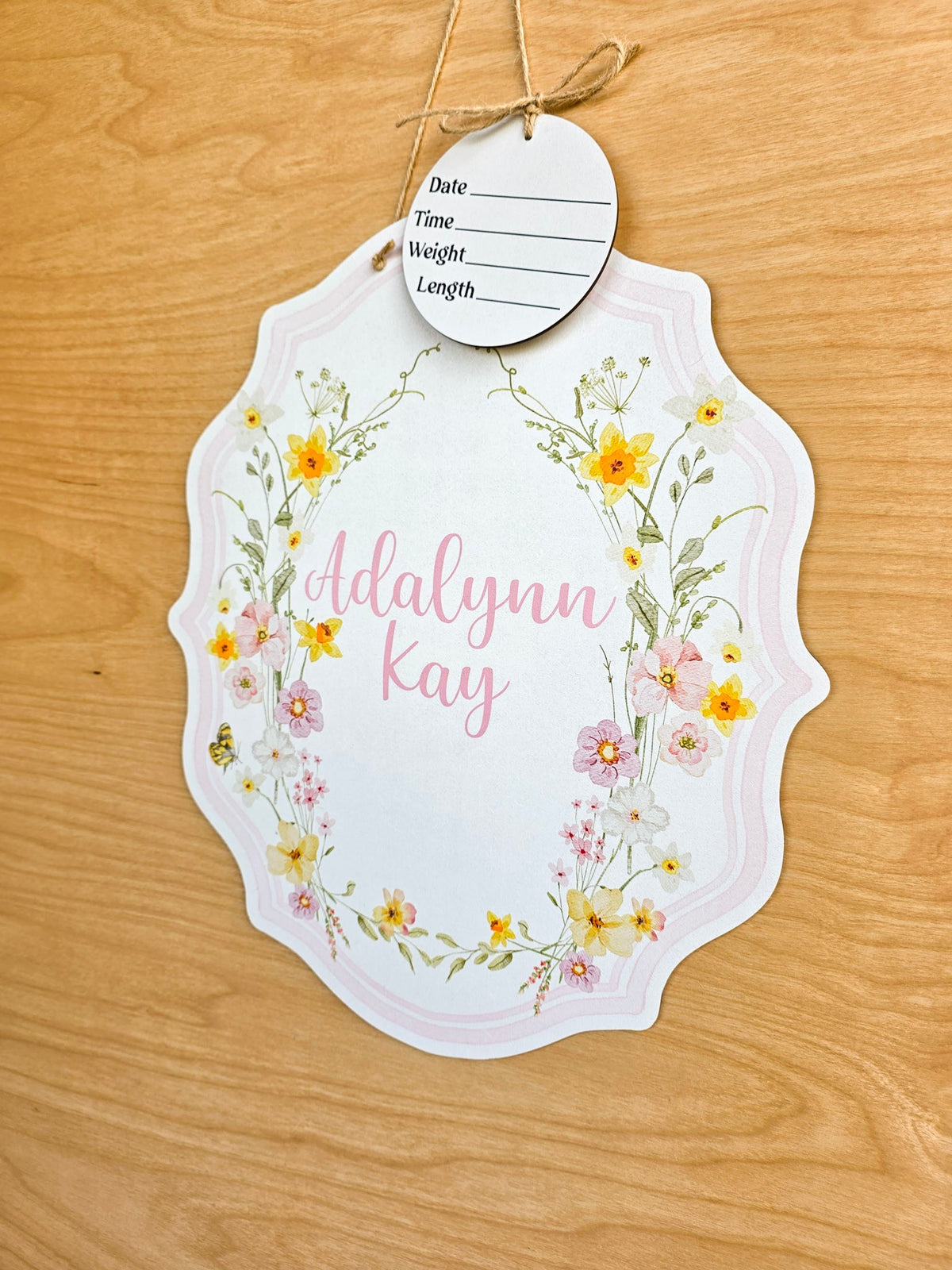 Watercolor yellow and blush pink spring flowers on a personalized baby name sign